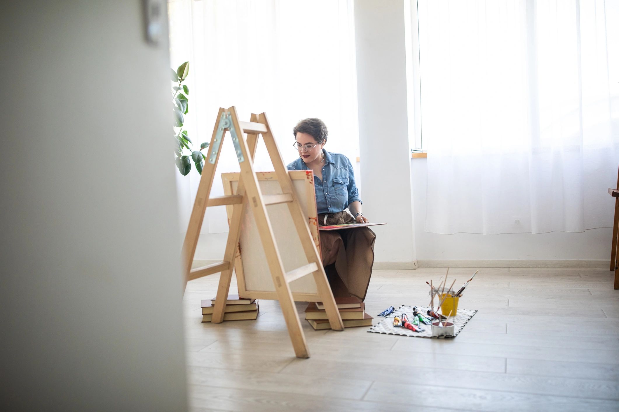 Artist painting with art supplies in a studio